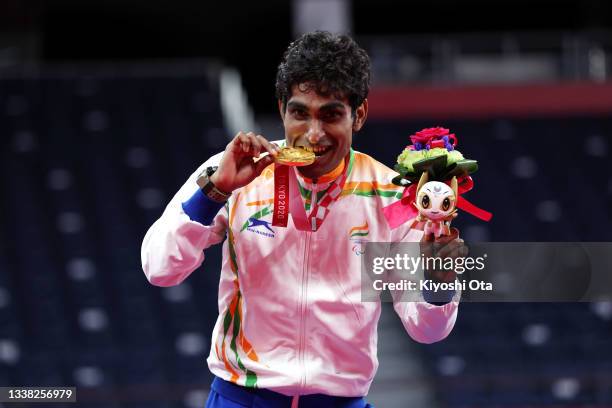Gold medalist Pramod Bhagat of Team India poses on the podium at the medal ceremony for the Men's Singles SL3 on day 11 of the Tokyo 2020 Paralympic...