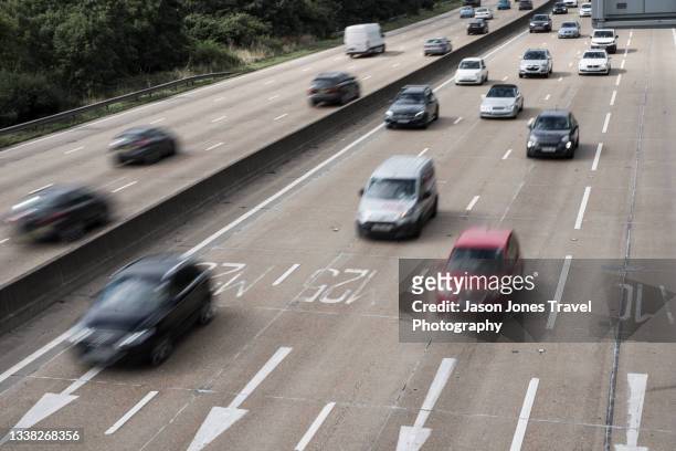 busy traffic on a motorway - heavy traffic stock pictures, royalty-free photos & images