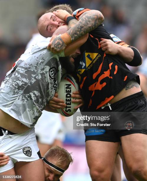 Devils player Sam Luckley is tackled by Tigers player Nathan Massey during the Betfred Super League match between Castleford Tigers and Salford Red...