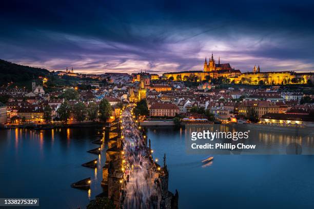 prague, twilight overview of charles bridge, city and river, czech republic - prague stock pictures, royalty-free photos & images