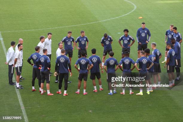 Hans-Dieter Flick, head coach of Germany talks to his players during a Germany Training session at Mercedes-Benz Arena on September 04, 2021 in...