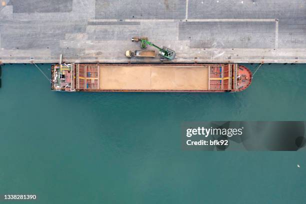 aerial view of a large cargo ship unloading grain. - rice production stockfoto's en -beelden