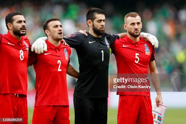 Emin Makhmudov, Gara Garayev, Shakhrudin Magomedaliyev and Maksim Medvedev of Azerbaijan stand for the national anthem prior to the 2022 FIFA World...