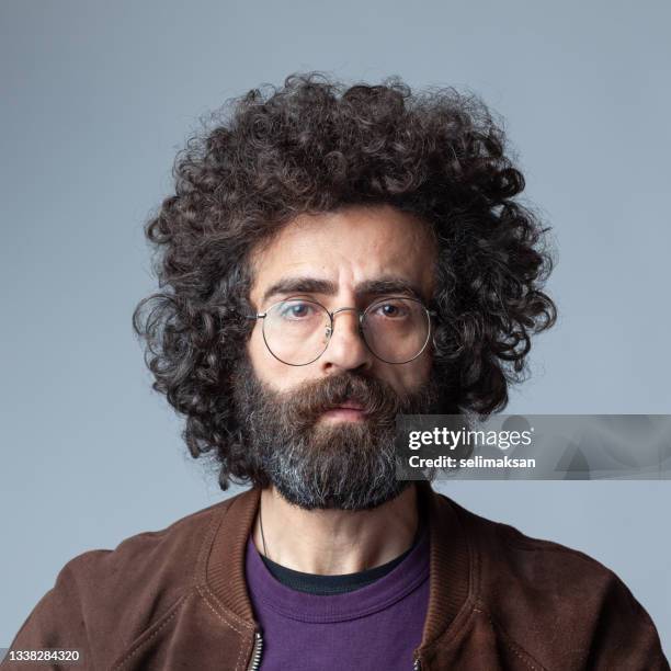mugshot of mature adult man with long curly hair and beard - long beard stock pictures, royalty-free photos & images