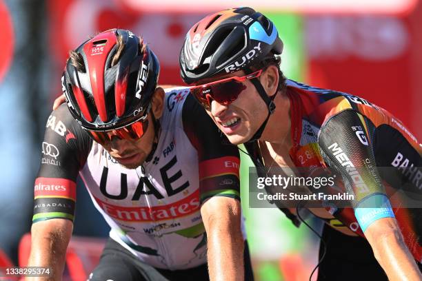 Ryan Gibbons of South Africa and UAE Team Emirates and Gino Mäder of Switzerland and Team Bahrain Victorious cross the finishing line during the 76th...