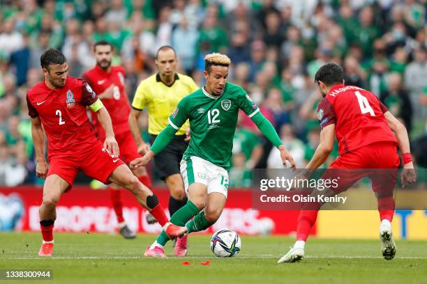 Callum Robinson of Republic of Ireland battles for possession with Gara Garayev and Hojjat Haghverdi of Azerbaijan during the 2022 FIFA World Cup...