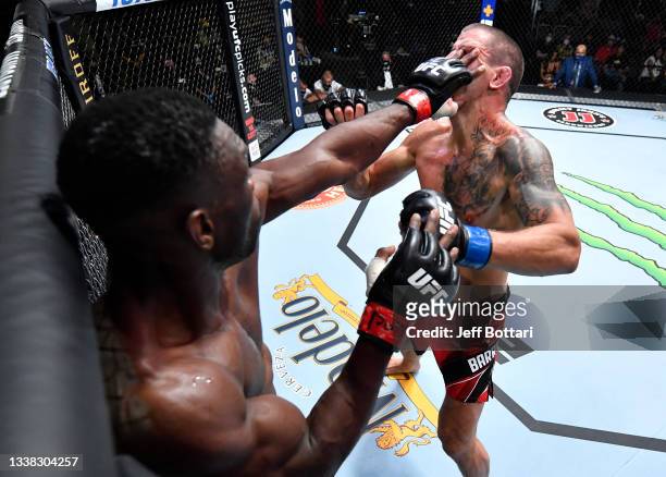 Dalcha Lungiambula of the Congo inadvertently pokes the eye of Marc-André Barriault of Canada in their middleweight fight during the UFC Fight Night...
