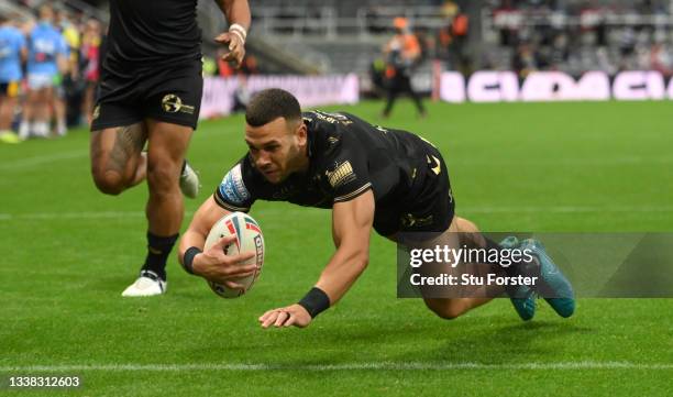 Hull FC player Carlos Tuimavave crosses for the second Hull try during the Betfred Super League match between Leeds Rhinos and Hull FC at St James'...