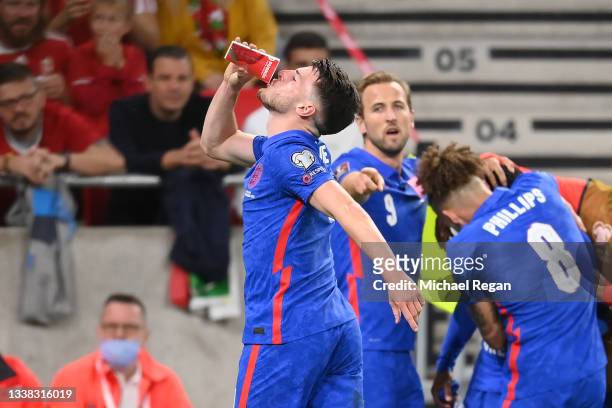 Declan Rice of England celebrates the first goal by drinking from a cup thrown by the crowd during the 2022 FIFA World Cup Qualifier between Hungary...