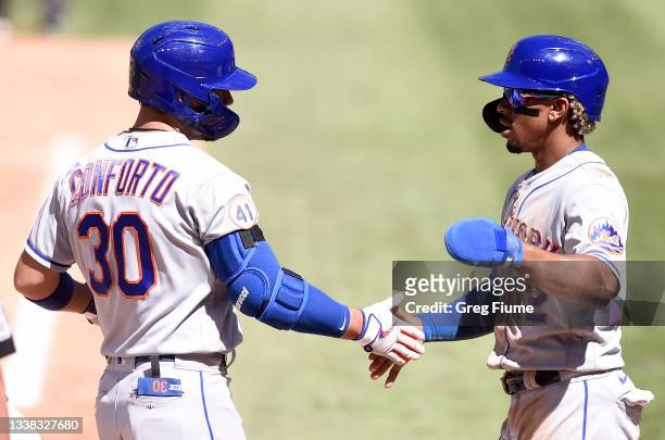 Michael Conforto of the New York Mets celebrates with Francisco Lindor after hitting a two-run home run in the fourth inning against the Washington...