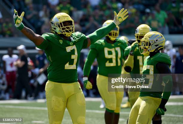 Defensive tackle Brandon Dorlus of the Oregon Ducks reacts after sacking quarterback Jake Haener of the Fresno State Bulldogs late during the fourth...