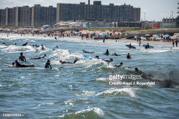 Surfers catch waves at Rockaway Beach over Labor Day Weekend on September 4, 2021 in the Brooklyn Borough of New York City. Some neighborhoods are...