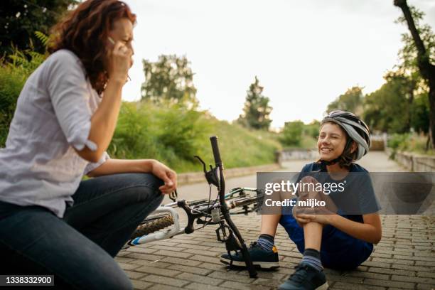 injured boy after falling down from bicycle - sport injury stock pictures, royalty-free photos & images