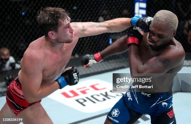 Darren Till of England punches Derek Brunson in their middleweight fight during the UFC Fight Night event at UFC APEX on September 04, 2021 in Las...