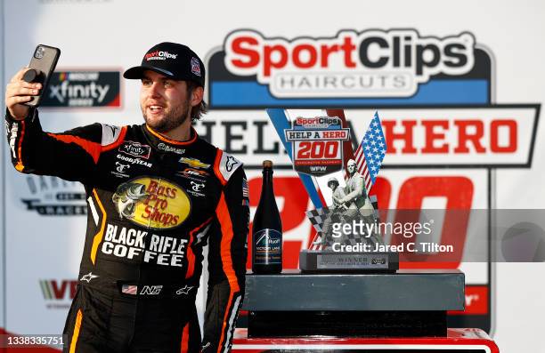 Noah Gragson, driver of the Bass Pro Shops/TrueTimber/BRCC Chevrolet, takes a selfie in the Ruoff Mortgage victory lane after winning the NASCAR...