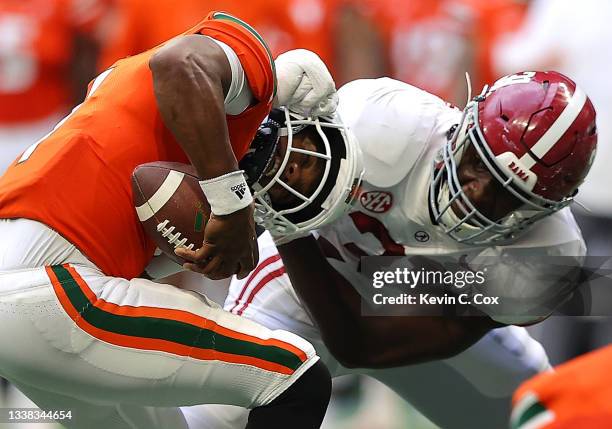 Eriq King of the Miami Hurricanes is escapes a sack attempt by Will Anderson Jr. #31 of the Alabama Crimson Tide during the second half of the...