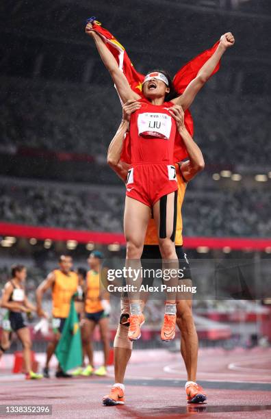 Cuiqing Liu of Team China and guide Donglin Xu celebrate winning the gold medal after competing in the Women's 200m - T11 Final on day 11 on day 11...