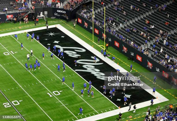 Players warm up before the Good Sam Vegas Kickoff Classic between the Brigham Young Cougars and the Arizona Wildcats at Allegiant Stadium on...