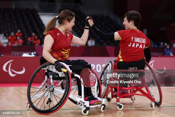 Sarina Satomi and Yuma Yamazaki of Team Japan celebrate a point during the Badminton Women's Doubles WH Gold Medal Match against Liu Yutong and Yin...