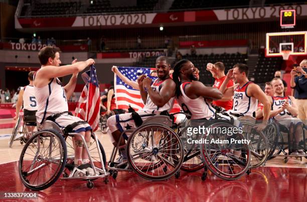 Joshua Turek, Brian Bell and Matt Scott of Team United States celebrate after defeating Team Japan during the men's Wheelchair Basketball gold medal...