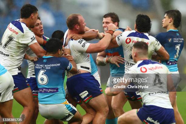 Jarrod Wallace of the Titans and Matthew Lodge of the Warriors grapple during the round 25 NRL match between the Gold Coast Titans and the New...