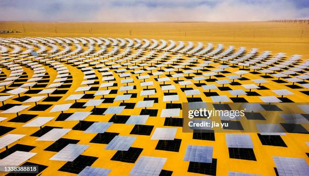 uav aerial photography, dunhuang photothermal power station, gansu province. many photovoltaic panels are placed in an arc shape towards the condensing tower in the center of the circle. - desert_climate stock pictures, royalty-free photos & images