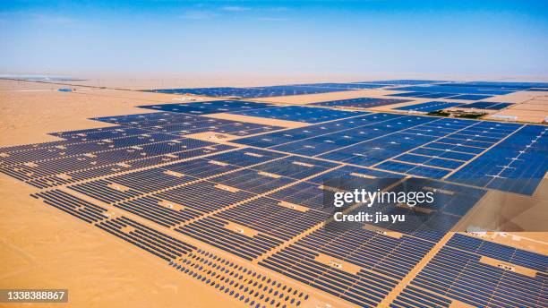 in the solar power station in the desert, large photovoltaic panels are placed neatly. dunhuang city, gansu province, china. - gobi desert stock pictures, royalty-free photos & images