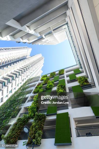 low angle view of apartment building with vertical garden - malaysia architecture stock pictures, royalty-free photos & images