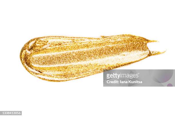 golden stroke of paint, nail polish on white background isolated. cosmetic products. makeup. - gold nail polish stock-fotos und bilder