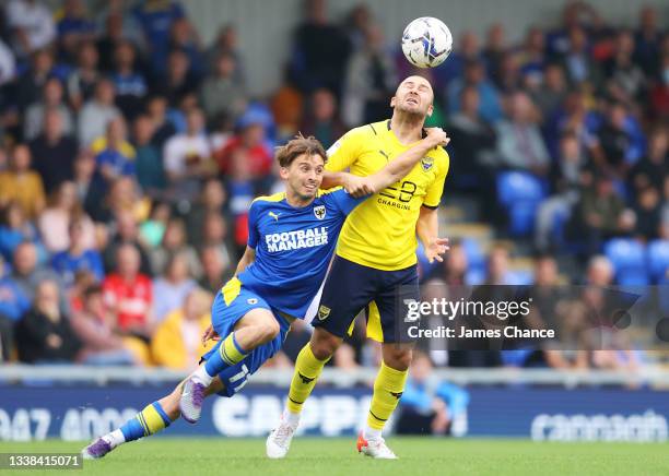 Herbie Kane of Oxford United is challenged by Ethan Chislett of AFC Wimbledon during the Sky Bet League One match between AFC Wimbledon and Oxford...