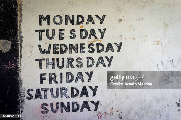 school wall in tanzania with days of the week - monday ストックフォトと画像