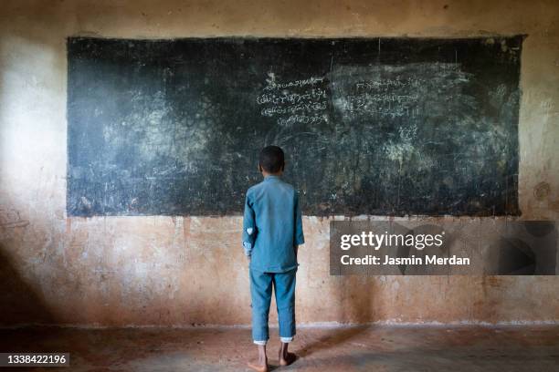 african child reading school blackboard - アフリカ　子供 ストックフォトと画像