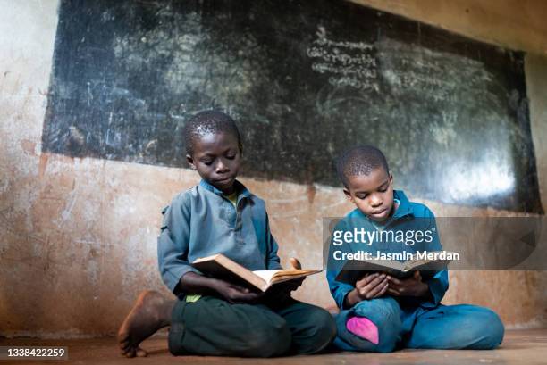 two african boys with book in school - アフリカ　子供 ストックフォトと画像
