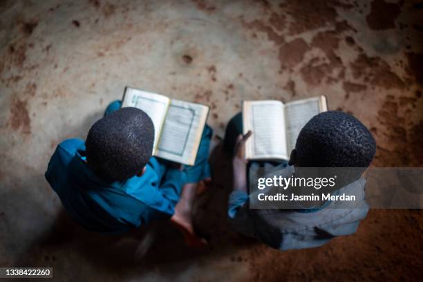 two african boys with book in school - east africa stock pictures, royalty-free photos & images