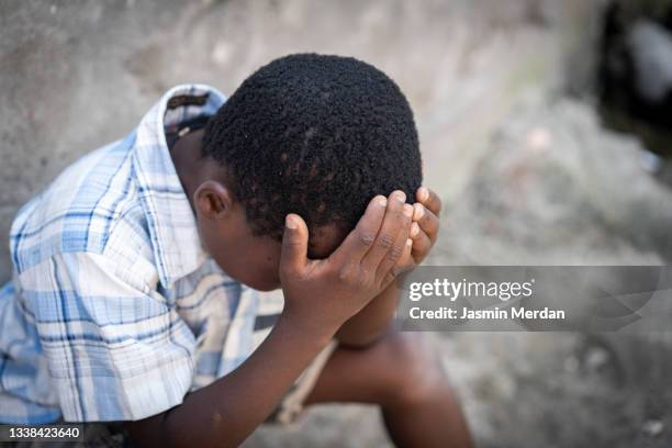african poor depressed crying boy - refugee camp imagens e fotografias de stock