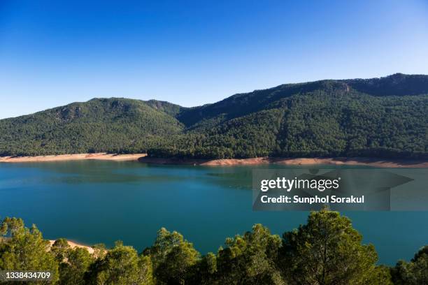 large lake surrounded by alpine mountain of embalse de el tranco de beas in sierra de segura range - cazorla stock pictures, royalty-free photos & images