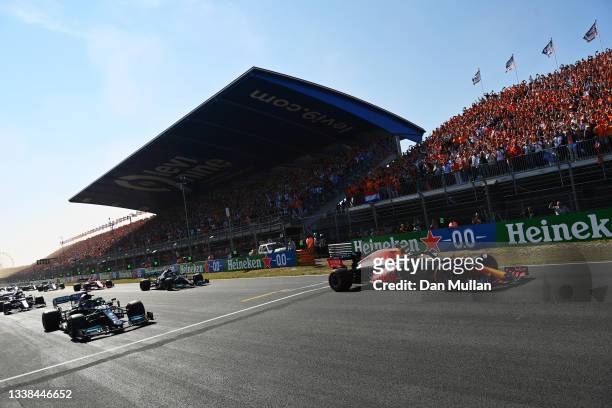 Max Verstappen of the Netherlands driving the Red Bull Racing RB16B Honda leads Lewis Hamilton of Great Britain driving the Mercedes AMG Petronas F1...