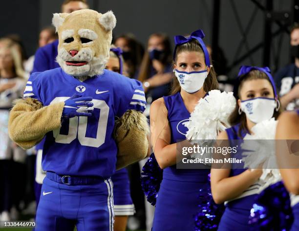 Brigham Young Cougars mascot Cosmo and cheerleaders stand on the team's sideline as the American national anthem is performed before the Good Sam...