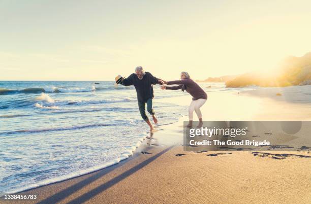 Mature woman playing with man at beach