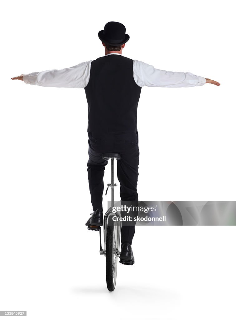 Business Man on a Unicycle Holding Arms out