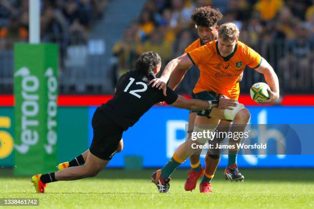 Matt Philip of the Wallabies tries to break the tackle of David Havili of the All Blacks during the Bledisloe Cup match between the Australian...