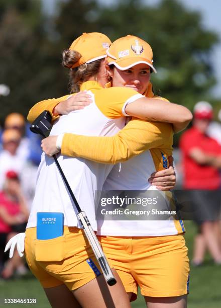 Mel Reid of Team Europe and Leona Maguire of Team Europe hug in the 14th green after winning the hole during the Foursomes Match on day two of the...