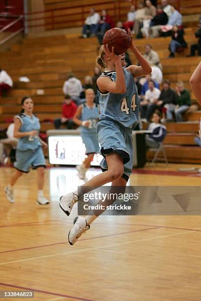 female basketball player in blue goes vertical in the lane - target sport stock pictures, royalty-free photos & images