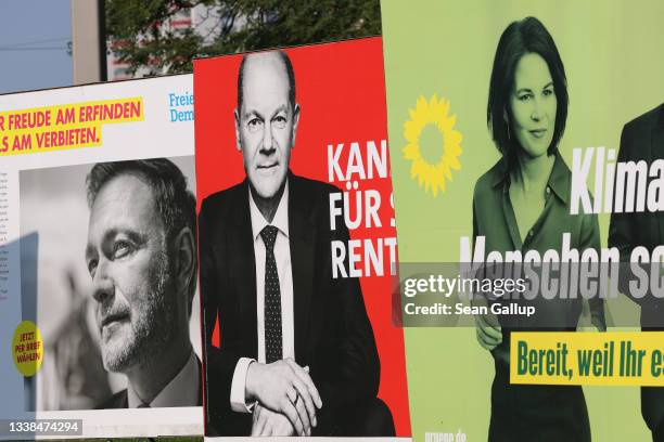 Election campaign billboards showing Christian Lindner , lead candidate of the German Free Democrats , Olaf Scholz , chancellor candidate of the...