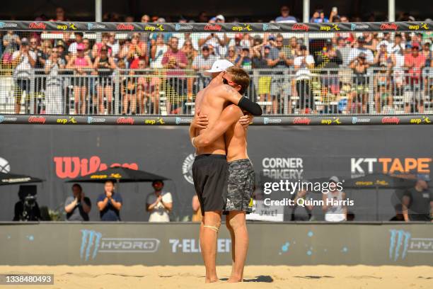 Jake Gibb and Taylor Crabb embrace after their match against Chase Budinger and Casey Patterson during the AVP Gold Series Chicago Open at the Oak...