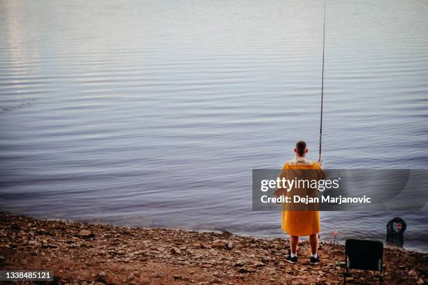 fishing alone - fishing hook worm stock pictures, royalty-free photos & images