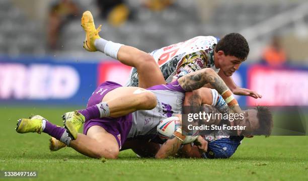 Hull KR player Ben Crooks is tackled around the neck by Keanan Brande during the Betfred Super League match between Leigh Centurions and Hull KR at...