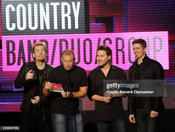 Musicians Chad Kroeger, Mike Kroeger, Ryan Peake and Daniel Adair of Nickelback present Favorite Country Band/Duo/Group onstage at the 2011 American...