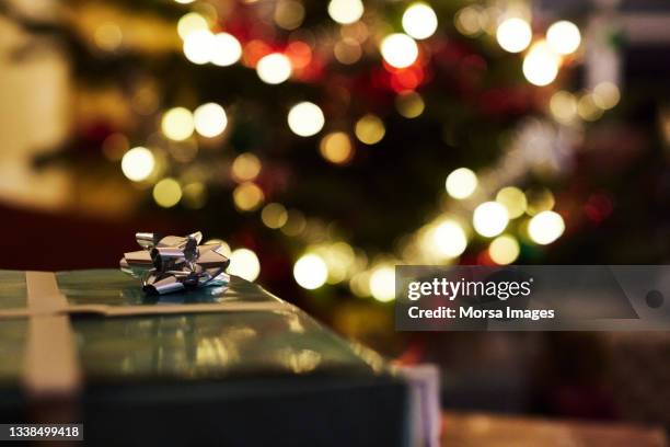 silver color ribbon on christmas present at home - night before stock pictures, royalty-free photos & images