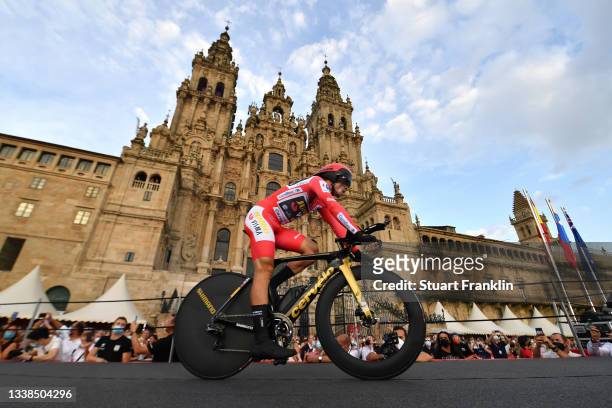 Primoz Roglic of Slovenia and Team Jumbo - Visma red leader jersey competes in the Plaza del Obradoiro with the Cathedral in the background during...